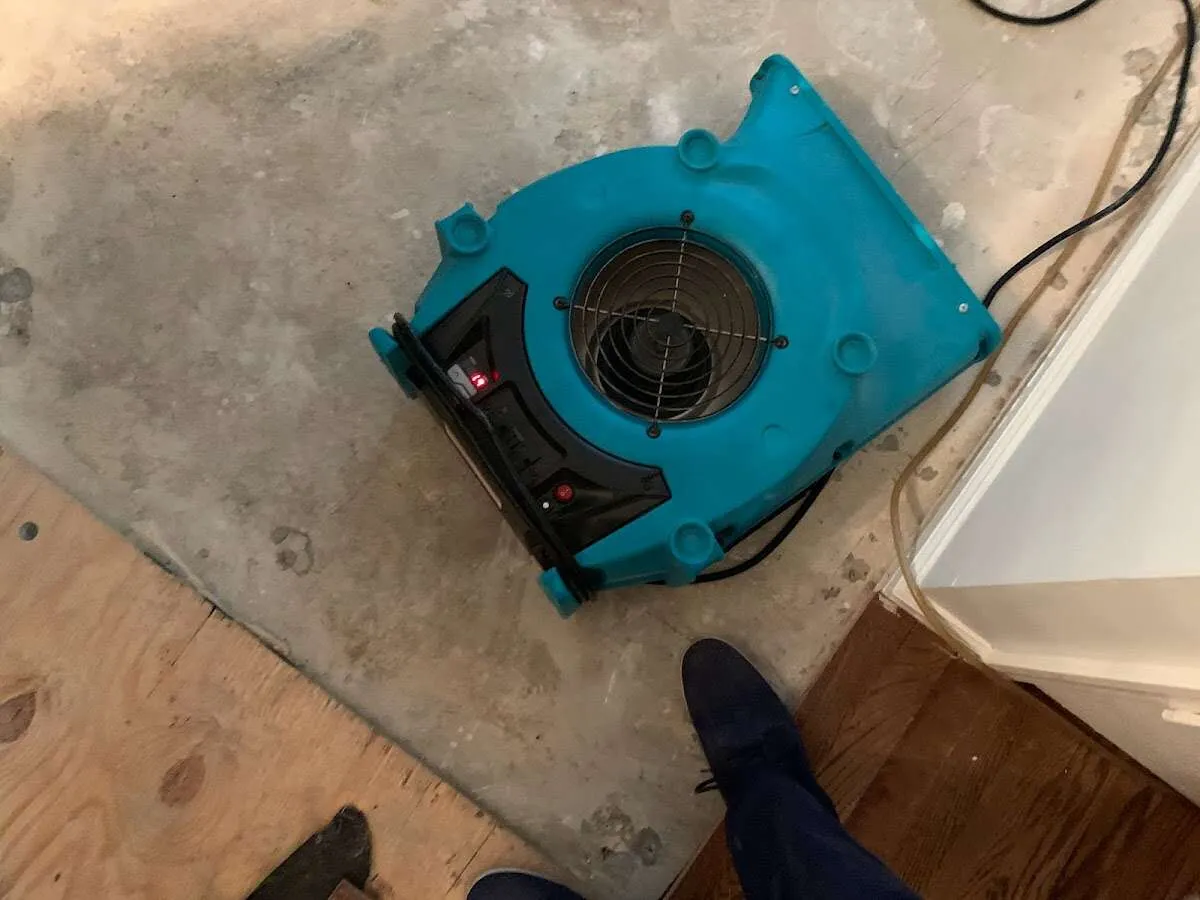 Air mover drying subfloor during Commercial Water Damage Restoration in Foxborough